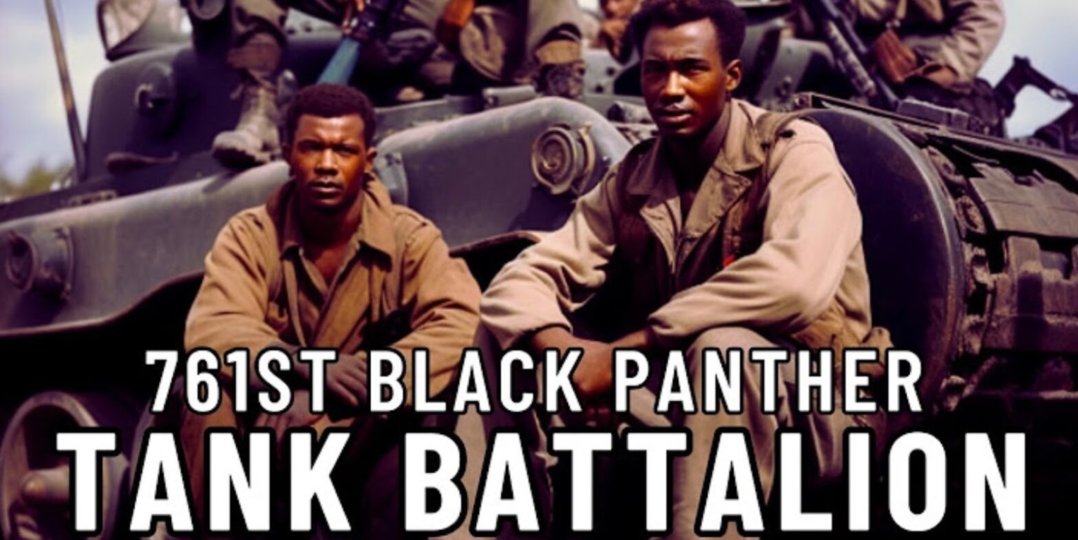 Men are sitting on a tank, in the foreground is the inscription 761st Tank Battalion